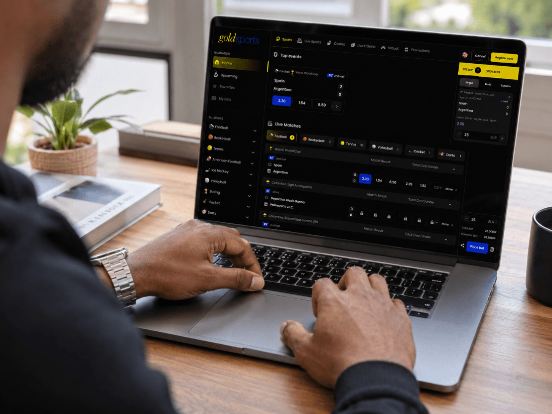 A sportsbook site open on a laptop, showing live football odds and a bet slip